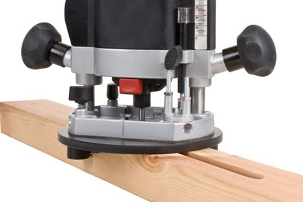 A router base used to guide a router along the centre of a piece of timber, to rout out mortises, without the need to measure and mark the mortise width. 