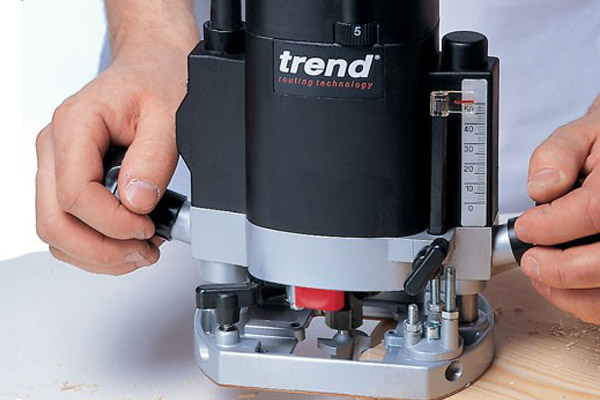 Using a router to cut down through the surface of a workpiece