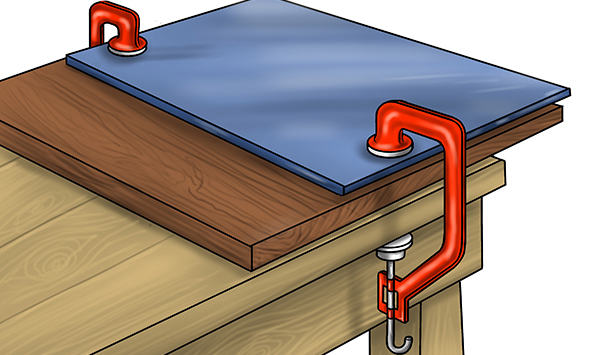 Material clamped to workbench with clamps, template clamped to workpiece