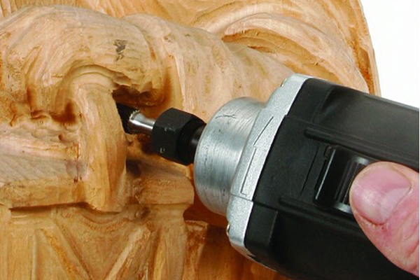 Enlarge a drilled hole with a burr fitted in a router