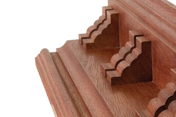 Wooden buttresses with a decorative pattern created by an ogee router cutter