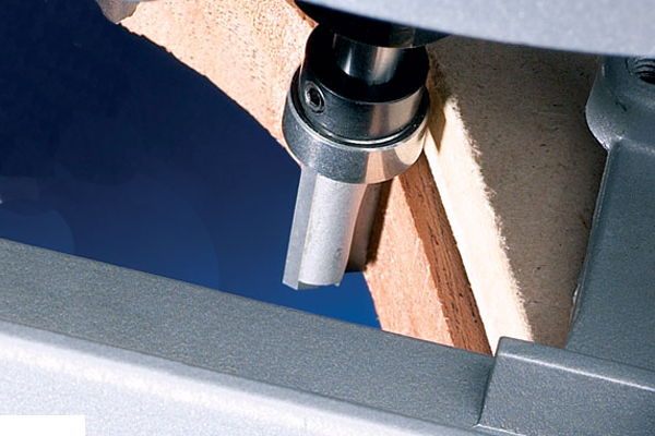 Image showing how a larger bearing guide can be used when trimming material down in stages, to reduce stress on the router cutter itself