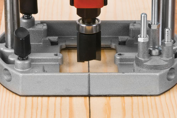 Using a router to cut down through the surface of a workpiece