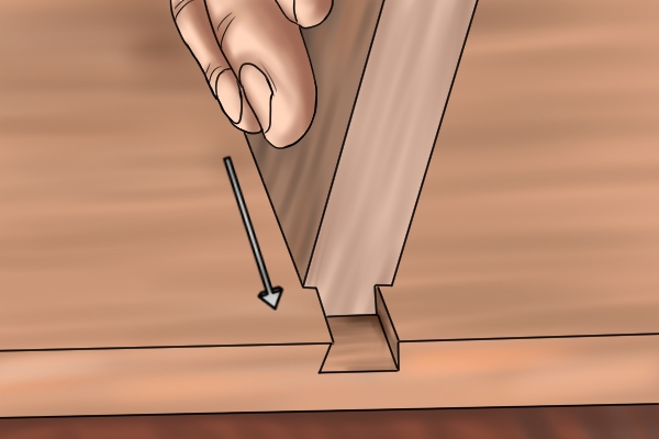 DIYer inserting a dovetail into a dovetail housing joint
